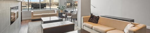 a living room with a couch and a table in the social room at Victoria Place Apartments
