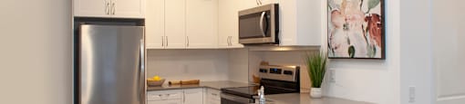 Kitchen with large built-in breakfast bar at Bayfield Tower Apartments in Barrie, ON