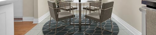 A dining room with a table set for six.