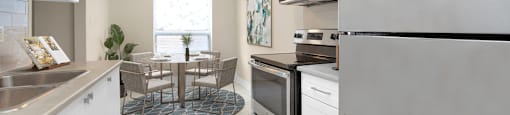 A modern kitchen with stainless steel appliances and white cabinets.