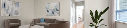 A living room with a brown sofa, a white coffee table, and a blue rug.