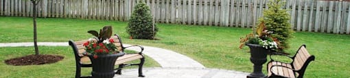 Wellington Park Towers beautifully landscaped grounds with benches in St. Thomas, ON