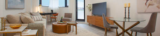 Living room, looking towards windows and patio door, at Bayfield Tower Apartments in Barrie, ON