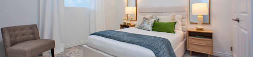 Primary bedroom, with view towards window featuring custom blinds, at Bayfield Tower Apartments in Barrie, ON
