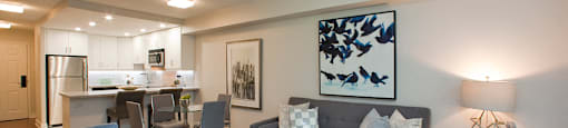 Brookbanks Elegant living room with glass coffee table and a grey couch in Toronto, ON