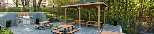 Brookbanks Apartments in Toronto, ON patio and BBQ area with picnic tables