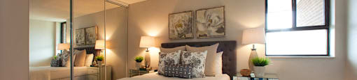 190 Cityview in Brampton, ON Bedroom with mirror door closet and two paintings above the bed