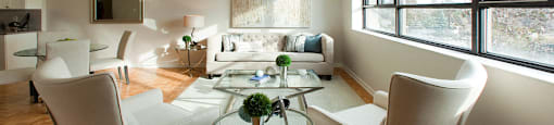 190 Cityview in Brampton, ON Modern living room with stylish white chairs and a glass table between them