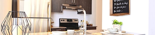 La Voile Boisbriand kitchen featuring stainless steel appliances and contemporary cabinetry in Boisbriand, QC