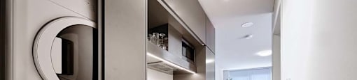 The Duke Vancouver BC A modern kitchen with a washer and dryer built into the cabinetry.
