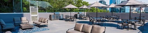 outdoor terrace with table and chairs at Victoria Place Apartments