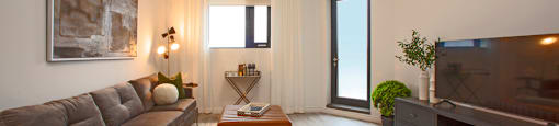 Living room as seen from the kitchen in a north-facing one bedroom apartment at Bayfield Tower Apartments in Barrie, ON