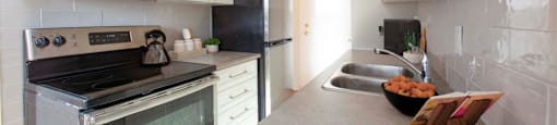 A kitchen with a stove, microwave, and refrigerator.