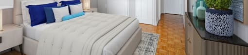 A bedroom with a large bed and a painting on the wall.