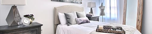 Brightly lit spacious bedroom at La Voile Broisbriand apartments in Broisbriand, Quebec