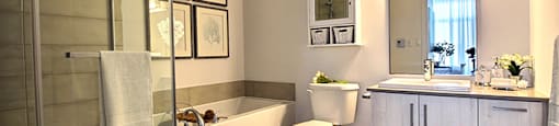 Spa like bathroom featuring standing, glass door shower and soaker tub at La Voile Broisbriand apartments