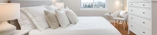 Bourg Du Village primary bedroom with sliding glass window and black-out blinds in Sainte Therese, QC