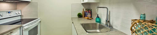 Wellington Park Towers kitchen with full range stove and microwave in St. Thomas, ON
