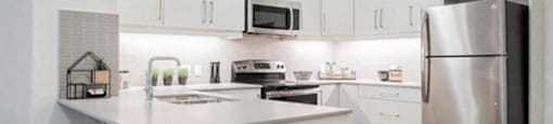 Upgraded kitchen with stainless steel appliances at 99 Jasper in Edmonton, AB