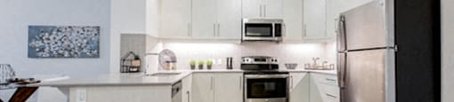 Kitchen with breakfast bar island at 99 Jasper in Edmonton, AB
