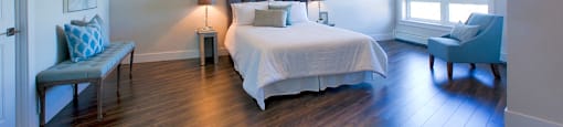Amesbury Gate Bedroom with a blue chair next to the window in Bedford, NS