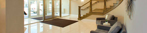 Amesbury Gate Fancy lobby with bright chandelier and staircase in Bedford, NS