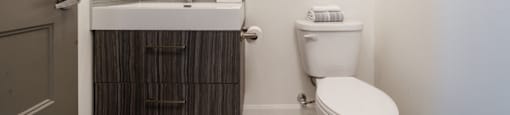 Modern half bath with spa premier finishes at Axial Towers apartment in Laval, Quebec