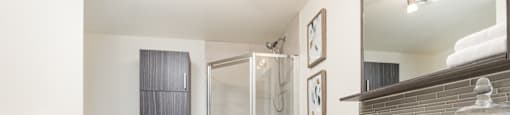 Large bathroom with spa finishes, tub and stand up shower at Axial Towers apartment in Laval, Quebec