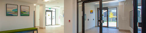 Lobby with wood-look tile flooring, looking towards entrances at Bayfield Tower Apartments in Barrie, ON