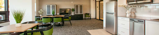 Social room with kitchenette, tables and chairs and a flat-screen TV at Bayfield Tower Apartments in Barrie, ON