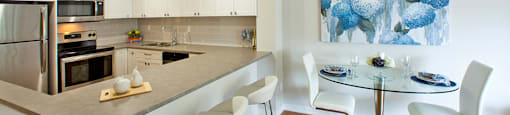 Bay Terrace kitchen with built-in breakfast bar next to dining area in Belleville, ON