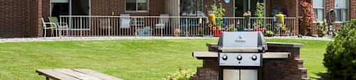 Shared outdoor seating and BBQ area at Bayview Towers in Sarnia, ON