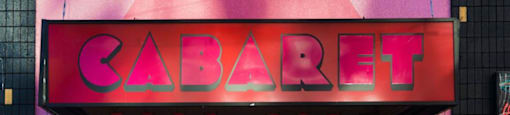 Pink building with sign that reads cab