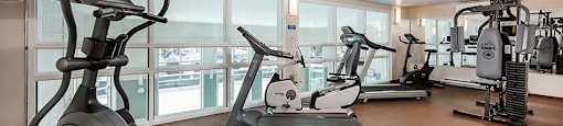 Bourg Du Village fitness facility with modern equipment and TV in Sainte Therese, QC