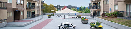 Braemar Gardens apartments courtyard with seating and planters in Coquitlam, BC