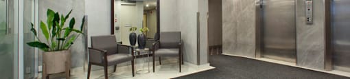 Brookbanks Apartments in Toronto, ON lobby and elevator area with lounge chairs