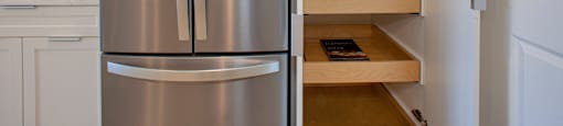 a kitchen with a refrigerator and some shelves