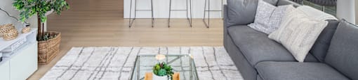 a living room and kitchen with a couch and a table