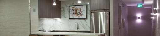 A modern kitchen with a bar area and stools.