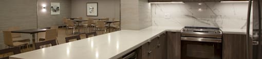 A modern kitchen with a large island and stainless steel appliances.