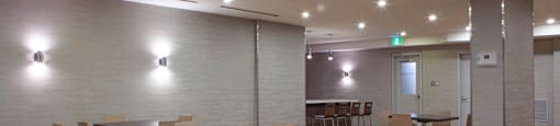 A conference room with a long table and chairs.