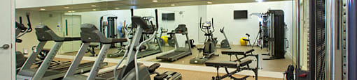 Cityview Apartments Fitness center with big mirror walls and weight lifting equipment in Brampton, ON