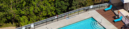 Cityview Apartments Crystal clear pool with four light blue chairs in Brampton, ON