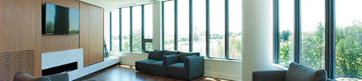 Cityview Apartments Social room with grey chairs and a flat screen tv in Brampton, ON