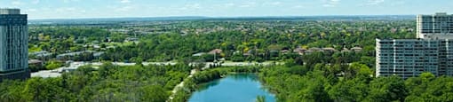View of lake surrounded by trees in Brampton, ON