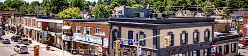 an aerial view of a city street with cars and buildings