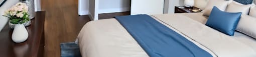A bedroom with a large bed and a view of the ocean through a window  at Angus House in Toronto  at Angus House in Toronto