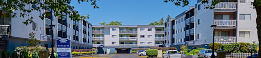 a parking lot in front of an apartment complex