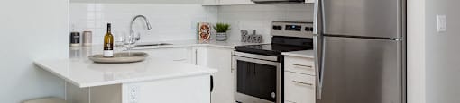 Glenmore Central in Kelowna, BC kitchen breakfast bar with quartz counter tops