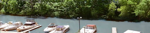 Harbourview Apartments building exterior featuring view of nearby marina in Oakville, ON